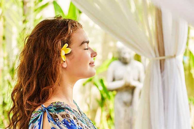 Girl relaxing with flower in her hair at Bliss Bali retreat