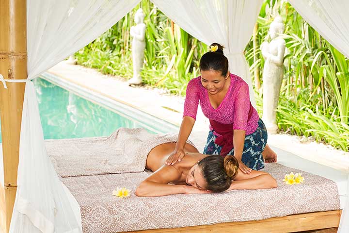 Woman receiving luxury massage by the pool at Bliss Sanctuary for Women