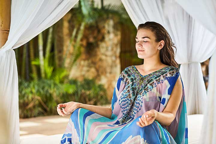 Bliss Bali retreat guest meditating wearing blue kaftan