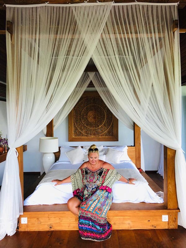 Zoe Watson Bliss Bali retreat founder relaxing on deluxe bed